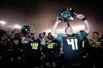 SAN DIEGO, CA - DECEMBER 30:  Daniel Padilla #41of the University of Oregon Ducks and teammates celebrate their 42-31 win over the Oklahoma State University Cowboys during the Pacific Life Holiday Bowl at Qualcomm Stadium on December 30, 2008 in San Diego, California. (Photo by Donald Miralle/Getty Images)