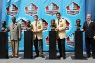 CANTON, OH - AUGUST 7: Pro Football Hall of Fame enshrinees and family members, (L-R) Dr. Steven Towns, grandson of enshrinee Fritz Pollardm, Steve Young of the San Francisco 49ers, Dan Marino of the Miami Dolphins and David Friedman, nephew of enshrinee Benny Friedman, pose the Hall of Fame busts during the 2005 NFL Hall of Fame enshrinment ceremony on August 7, 2005 in Canton, Ohio. (Photo by Jonathan Daniel/Getty Images)