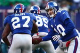 EAST RUTHERFORD, NJ -  JANUARY 11:  Eli Manning #10 of the New York Giants looks to hand off the ball against the Philadelphia Eagles during the NFC Divisional Playoff Game on January 11, 2009 at Giants Stadium in East Rutherford, New Jersey.  The Eagles defeated the Giants 23 -11. (Photo by Chris McGrath/Getty Images)