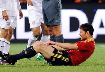 BLOEMFONTEIN, SOUTH AFRICA - JUNE 24: Landon Donovan #10 of USA gets a yellow card from referee Jorge Larrionda of Uruguay for a foul against Xabi Alonso #14 of Spain during the FIFA Confederations Cup Semi Final match between Spain and USA at the Free State stadium on June 24, 2009 in Bloemfontein, South Africa. USA won, 2-0, to advance to the finals.  (Photo by Kevork Djansezian/Getty Images)