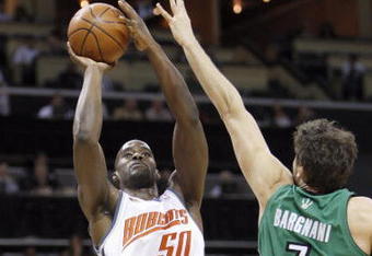 CHARLOTTE, NC - MARCH 16:  Emeka Okafor #50 of the Charlotte Bobcats takes a shot against Andrea Bargnani #7 of the Toronto Raptors during their game at Time Warner Cable Arena on March 16, 2009 in Charlotte, North Carolina.  NOTE TO USER: User expressly acknowledges and agrees that, by downloading and/or using this Photograph, user is consenting to the terms and conditions of the Getty Images License Agreement. (Photo by: Streeter Lecka/Getty Images)