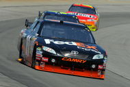 LONG POND, PA - AUGUST 03:  Denny Hamlin, driver of the #11 FedEx Express Toyota, leads Jimmie Johnson, driver of the #48 Lowe's Chevrolet, and Jeff Gordon, driver of the #24 DuPont Chevrolet, during the NASCAR Sprint Cup Series Sunoco Red Cross Pennsylvania 500 at the Pocono Raceway on August 3, 2009 in Long Pond, Pennsylvania.  (Photo by Doug Pensinger/Getty Images)