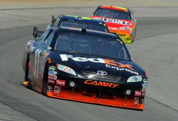 LONG POND, PA - AUGUST 03:  Denny Hamlin, driver of the #11 FedEx Express Toyota, leads Jimmie Johnson, driver of the #48 Lowe's Chevrolet, and Jeff Gordon, driver of the #24 DuPont Chevrolet, during the NASCAR Sprint Cup Series Sunoco Red Cross Pennsylvania 500 at the Pocono Raceway on August 3, 2009 in Long Pond, Pennsylvania.  (Photo by Doug Pensinger/Getty Images)
