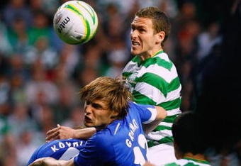 GLASGOW, SCOTLAND - JULY 29:  Chris Killen of Celtic jumps above Vladimir Granat and Denis Kolodin of Dinamo Moscow during the UEFA Champions League qualifying match between Celtic and Dinamo Moscow at Celtic Park on July 29, 2009 in Glasgow, Scotland.  (Photo by Jeff J Mitchell/Getty Images)