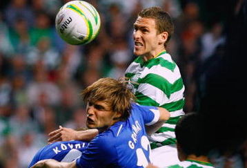 GLASGOW, SCOTLAND - JULY 29:  Chris Killen of Celtic jumps above Vladimir Granat and Denis Kolodin of Dinamo Moscow during the UEFA Champions League qualifying match between Celtic and Dinamo Moscow at Celtic Park on July 29, 2009 in Glasgow, Scotland.  (Photo by Jeff J Mitchell/Getty Images)
