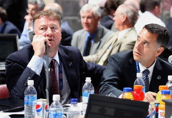 MONTREAL, QC - JUNE 27:  (L-R) General Manager Mike Gillis and assistant General Manager Laurence Gilman of the Vancouver Canucks sit at the draft table during the 2009 NHL Entry Draft at the Bell Centre on June 27, 2009 in Montreal, Quebec, Canada. (Photo by Bruce Bennett/Getty Images) 