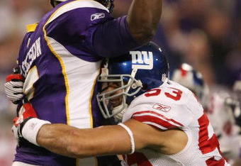 MINNEAPOLIS - DECEMBER 28:   Quarterback Tarvaris Jackson #7 of the Minnesota Vikings is hit by Bryan Kehl #53 of the New York Giants on December 28, 2008 at the Hubert H. Humphrey Metrodome in Minneapolis, Minnesota. (Photo by Elsa/Getty Images)
