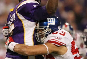 MINNEAPOLIS - DECEMBER 28:   Quarterback Tarvaris Jackson #7 of the Minnesota Vikings is hit by Bryan Kehl #53 of the New York Giants on December 28, 2008 at the Hubert H. Humphrey Metrodome in Minneapolis, Minnesota. (Photo by Elsa/Getty Images)