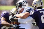 SEATTLE - SEPTEMBER 6:  Nate Williams #8 and Mesphin Forrester #23 of the Washington Huskies tackle a  BYU Cougars player during their game on September 6, 2008 at Husky Stadium in Seattle, Washington. The Cougars defeated the Huskies 28-27. (Photo by Otto Greule Jr/Getty Images)