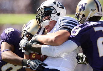 SEATTLE - SEPTEMBER 6:  Nate Williams #8 and Mesphin Forrester #23 of the Washington Huskies tackle a  BYU Cougars player during their game on September 6, 2008 at Husky Stadium in Seattle, Washington. The Cougars defeated the Huskies 28-27. (Photo by Otto Greule Jr/Getty Images)
