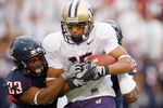 TUSCON - OCTOBER 4:  Jermaine Kearse #15 of the Washington Huskies grips the ball as he is tackled by Marquis Hundley #23 of the Arizona Wildcats on October 4, 2008 at Arizona Stadium in Tucson, Arizona. (Photo by: Gregory Shamus/Getty Images)