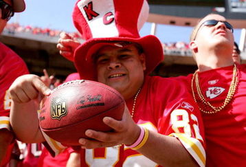KANSAS CITY, MO - OCTOBER 01:  A fan displays the football present to him by Dante Hall #82 of the Kansas City Chiefs after he returned a punt 60 yards against the San Francisco 49ers for a fourth quarter touchdown and the score of the game as the Chiefs defeated the 49ers 41-0 during week four NFL action on October 1, 2006 at Arrowhead Stadium in Kansas City, Missouri.  (Photo by Doug Pensinger/Getty Images)