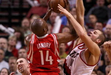 PORTLAND, OR - APRIL 28:  Carl Landry #14 of the Houston Rockets is guarded by Joel Przybilla #10 and Steve Blake #2 of the Portland Trail Blazers during Game 5 of the Western Conference Quarterfinals of the NBA Playoffs on April 28, 2009 at the Rose Garden in Portland, Oregon. NOTE TO USER: User expressly acknowledges and agrees that, by downloading and or using this Photograph, user is consenting to the terms and conditions of the Getty Images License Agreement.  (Photo by Jonathan Ferrey/Getty Images)