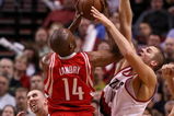 PORTLAND, OR - APRIL 28:  Carl Landry #14 of the Houston Rockets is guarded by Joel Przybilla #10 and Steve Blake #2 of the Portland Trail Blazers during Game 5 of the Western Conference Quarterfinals of the NBA Playoffs on April 28, 2009 at the Rose Garden in Portland, Oregon. NOTE TO USER: User expressly acknowledges and agrees that, by downloading and or using this Photograph, user is consenting to the terms and conditions of the Getty Images License Agreement.  (Photo by Jonathan Ferrey/Getty Images)