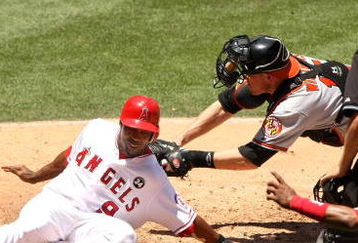ANAHEIM, CA - JULY 05:  Chone Figgins #9 of the Los Angeles Angels of Anaheim slides safely into home ahead of the tag o catcher Matt Wieters #15 of fthe Baltimore Orioles in the third inning on July 5, 2009 at Angel Stadium in Anaheim, California. The Angels won 9-6.  (Photo by Stephen Dunn/Getty Images)