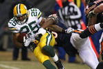 CHICAGO - DECEMBER 22: Ryan Grant #25 of the Green Bay Packers tries to break away from Nick Roach #53 of the Chicago Bears on December 22, 2008 at Soldier Field in Chicago, Illinois. (Photo by Jonathan Daniel/Getty Images)