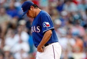 ARLINGTON, TX - JULY 17:  Pitcher Vicente Padilla #44 of the Texas Rangers reacts after giving up a three run homerun against Jason Kubel #16 of the Minnesota Twins on July 17, 2009 at Rangers Ballpark in Arlington, Texas.  (Photo by Ronald Martinez/Getty Images)