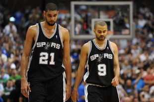 DALLAS - APRIL 25:  Forward Tim Duncan #21 and Tony Parker #9 of the San Antonio Spurs during a 99-90 loss against the Dallas Mavericks in Game Four of the Western Conference Quarterfinals during the 2009 NBA Playoffs at American Airlines Center on April 25, 2009 in Dallas, Texas. NOTE TO USER: User expressly acknowledges and agrees that, by downloading and or using this photograph, User is consenting to the terms and conditions of the Getty Images License Agreement.  (Photo by Ronald Martinez/Getty Images)