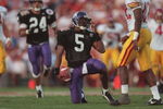 1 Jan 1996:  Running back D'Wayne Bates #5 of the Northwestern Wildcats reaches for his helmet as he attempts to remove a clump of grass from his face mask following a carry in the Wildcats 41-32 loss to the USC Trojans in the 1996 Rose Bowl game held at