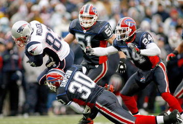ORCHARD PARK, NY - DECEMBER 28: Wes Welker #83 of the New England Patriots falls forward for a first down ahead of Ko Simpson #30, Paul Posluszny #51 and Terrence McGee #24 of the Buffalo Bills at Ralph Wilson Stadium December 28, 2008 in Orchard Park, New York.  (Photo by Rick Stewart/Getty Images)