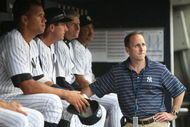 NEW YORK - JULY 2: Alex Rodriguez #2 (L) of the New York Yankees sits on the bench, joined by Yankees General Manager Brian Cashman (R) before a game against the Seattle Mariners at Yankee Stadium on July 2, 2009 in the Bronx borough of New York City. (Photo by Nick Laham/Getty Images)