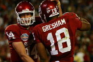 MIAMI - JANUARY 08:  Sam Bradford #14 of the Oklahoma Sooners celebrates with teammates Jermaine Gresham #18 after scoring a touchdown againist the Florida Gators during the FedEx BCS National Championship Game at Dolphin Stadium on January 8, 2009 in Miami, Florida.  (Photo by Donald Miralle/Getty Images)