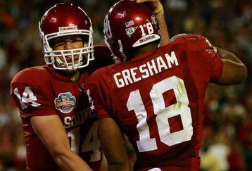 MIAMI - JANUARY 08:  Sam Bradford #14 of the Oklahoma Sooners celebrates with teammates Jermaine Gresham #18 after scoring a touchdown againist the Florida Gators during the FedEx BCS National Championship Game at Dolphin Stadium on January 8, 2009 in Miami, Florida.  (Photo by Donald Miralle/Getty Images)
