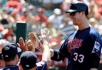 ANAHEIM, CA - JULY 26:  Justin Morneau #33 of the Minnesota Twins celebrates his second home run of the game with teammates in the seventh inning against the Los Angeles Angels of Anaheim at Angels Stadium on July 26, 2009 in Anaheim, California. (Photo by Harry How/Getty Images)