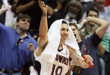 ATLANTA - MAY 03:  Mike Bibby #10 of the Atlanta Hawks celebrates from the bench late in the game against the Miami Heat during Game Seven of the Eastern Conference Quarterfinals at Philips Arena on May 3, 2009 in Atlanta, Georgia. The Hawks defeated the Heat 91-78. NOTE TO USER: User expressly acknowledges and agrees that, by downloading and/or using this Photograph, user is consenting to the terms and conditions of the Getty Images License Agreement.  (Photo by Doug Benc/Getty Images)
