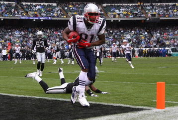 OAKLAND, CA - DECEMBER 14:  Randy Moss #81 of the New England Patriots catches a touchdown in the first quarter past Rashard Baker #27 of the Oakland Raiders during an NFL game on December 14, 2008 at the Oakland-Alameda County Coliseum in Oakland, California.  (Photo by Jed Jacobsohn/Getty Images)