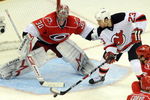 RALEIGH, NC - APRIL 26: Goalie Cam Ward #30 of the Carolina Hurricanes keeps a close eye on the puck as David Clarkson #23 of the New Jersey Devils tries to get it past him in the third period of Game Six of the Eastern Conference Quarterfinals of the 2009 Stanley Cup Playoffs on April 26, 2009 at the RBC Center in Raleigh, North Carolina. (Photo by Steve Dykes/Getty Images)