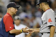 NEW YORK - AUGUST 6:  Manager Terry Francona of the Boston Red Sox takes the ball from pitcher John Smoltz #29 as he takes him out of the game in the fourth inning against the New York Yankees on August 6, 2009 at Yankee Stadium in the Bronx borough of New York City. The Yankees defeated the Red Sox 13-6.  (Photo by Paul Bereswill/Getty images)