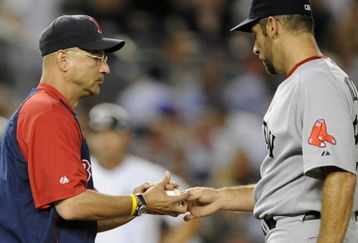 NEW YORK - AUGUST 6:  Manager Terry Francona of the Boston Red Sox takes the ball from pitcher John Smoltz #29 as he takes him out of the game in the fourth inning against the New York Yankees on August 6, 2009 at Yankee Stadium in the Bronx borough of New York City. The Yankees defeated the Red Sox 13-6.  (Photo by Paul Bereswill/Getty images)