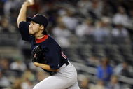 NEW YORK - AUGUST 07:  Junichi Tazawa #63 of the Boston Red Sox pitches against the New York Yankees in the 14th inning of the game on August 7, 2009 at Yankee Stadium in the Bronx borough of New York City.  (Photo by Jeff Zelevansky/Getty Images)