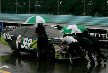 WATKINS GLEN, NY - AUGUST 09:  Crew members push the #99 Aflac Ford, driven by Carl Edwards, off the grid after a rain delay in the NASCAR Sprint Cup Series Heluva Good! Sour Cream Dips at Watkins Glen International on August 9, 2009 in Watkins Glen, New York.  (Photo by Todd Warshaw/Getty Images for NASCAR)