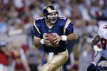 TAMPA, FL - SEPTEMBER 23:  Quarterback Kurt Warner #13 of the St. Louis Rams rolls to his right during the NFL game against the Tampa Bay Buccaneers on September 23, 2002 at Raymond James Stadium in Tampa, Florida. The Buccaneers won 26-14. (Photo by Andy Lyons/Getty Images)