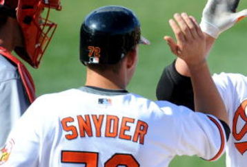 FORT LAUDERDALE, FL - FEBRUARY 26: Scott Moore #26 of the Baltimore Orioles gets greeted by his teammates Brandon Snyder #72 and Luis Motanez #12 after hitting a three home run against the St Louis Cardinals during a spring training game at Fort Lauderdale Stadium on February 26, 2009 in Fort Lauderdale, Florida. (Photo by Rob Tringali/Getty Images)