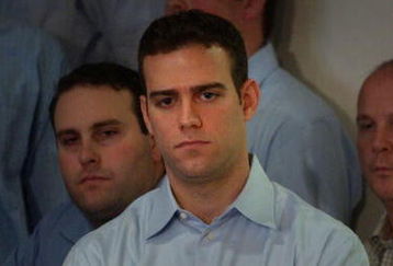 BOSTON - NOVEMBER 2:  Former Red Sox general manager Theo Epstein looks on November 2, 2005 as principal owner John Henry speaks with the media at Fenway Park in Boston, Massachusetts. Epstein resigned as general manager on October 31 nearly a year after the franchise won its first World Series championship since 1918.  (Photo by Darren McCollester/Getty Images)