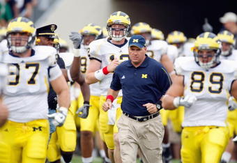 SOUTH BEND,IN - SEPTEMBER 13:  Head coach Rich Rodriguez of the Michigan Wolverines runs onto the field with his team before the game against the Notre Dame Fighting Irish on September 13, 2008 at Notre Dame Stadium in South Bend, Indiana. (Photo by: Gregory Shamus/Getty Images)