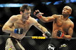 PHILADELPHIA - AUGUST 08:  Anderson Silva (R) throws a right punch to Forrest Griffin during their light heavyweight bout at UFC 101: Declaration at the Wachovia Center on August 8, 2009 in Philadelphia, Pennsylvania.  (Photo by Jon Kopaloff/Getty Images)
