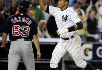 NEW YORK - AUGUST 07:  Alex Rodriguez #13 of the New York Yankees celebrates a walk off home run in the 15th inning as losing pitcher Junichi Tazawa #63 of the Boston Red Sox walks off the field on August 7, 2009 at Yankee Stadium in the Bronx borough of New York City.  The New York Yankees defeated the Boston Red Sox 2-0.  (Photo by Jeff Zelevansky/Getty Images)