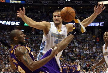 DENVER - MAY 29:  Kobe Bryant #24 of the Los Angeles Lakers falls down as the ball flies in the air in front of Linas Kleiza #43 of the Denver Nuggets in Game Six of the Western Conference Finals during the 2009 NBA Playoffs at Pepsi Center on May 29, 2009 in Denver, Colorado. NOTE TO USER: User expressly acknowledges and agrees that, by downloading and or using this photograph, User is consenting to the terms and conditions of the Getty Images License Agreement.  (Photo by Jed Jacobsohn/Getty Images)
