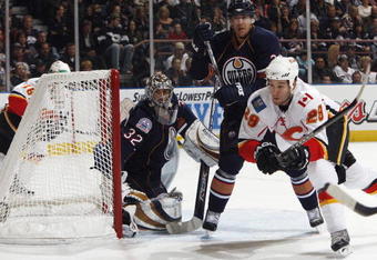 EDMONTON, CANADA - October 18: Goaltender Mathieu Garon #32 and Steve Staios #24 of the Edmonton Oilers defend against Brandon Prust #29 of the Calgary Flames during their NHL game on October 18, 2008 at Rexall Place in Edmonton, Alberta, Canada. (Photo by Dale MacMillan/Getty Images)