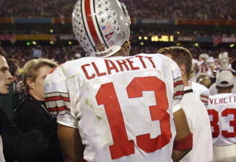 TEMPE, AZ - JANUARY 3:  Freshman running back Maurice Clarett #13 of the Ohio State Buckeyes takes in the BCS Championship victory over the University of Miami Hurricanes in the Tostitos Fiesta Bowl at Sun Devil Stadium on January 3, 2003  in Tempe, Arizona.  Ohio State won the game 31-24 in double-overtime, winning the NCAA National Championship.  (Photo by Brian Bahr/Getty Images)