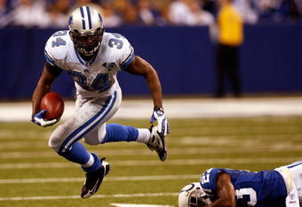 INDIANAPOLIS - DECEMBER 14:  Kevin Smith #34 of the Detroit Lions avoids a tackle by Tim Jennings #23 of the Indianapolis Colts on December 14, 2008 at Lucas Oil Stadium in Indianapolis, Indiana.  The Colts defeated the Lions 31-21.  (Photo by Chris Graythen/Getty Images)