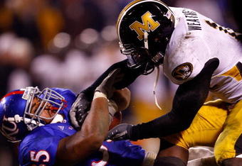 KANSAS CITY, MO - NOVEMBER 24:  Brandon McAnderson #35 of the Kansas Jayhawks is brought down by Sean Weatherspoon #12 of the Missouri Tigers during the game at Arrowhead Stadium November 24, 2007 in Kansas City, Missouri.  (Photo by Jamie Squire/Getty Images)