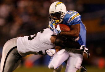 SAN DIEGO - DECEMBER 04:  Running Back Darren Sproles #43 is hit by Derrick Burgess #56 of the Oakland Raiders during their NFL Game on December 4, 2008 at Qualcomm Stadium in San Diego, California.  (Photo by Harry How/Getty Images)