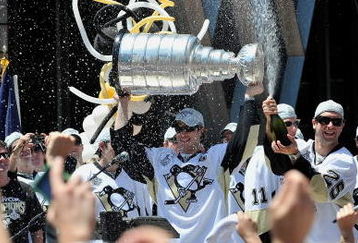 PITTSBURGH - JUNE 15:  Sidney Crosby #87 of the Pittsburgh Penguins holds the Stanley Cup as Maxime Talbot #25 of the Penguins sprays the crowd during Stanley Cup Champion Victory Parade on June 15, 2009 in Pittsburgh, Pennsylvania.  (Photo by Jamie Sabau/Getty Images)