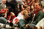 7 Jun 1996:  Dennis Rodman of the Chicago Bulls gets a pat on the head from a fan after crashing into photographers on the sidelines during third quarter action of game two of the NBA Finals at the United Center in Chicago, Illinois. The Bulls lead the se