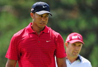 AKRON, OH - AUGUST 09:  Tiger Woods of USA and Padraig Harrington (R) of Ireland size up their putts on the first hole during the final round of the World Golf Championship Bridgestone Invitational on August 9, 2009 at Firestone Country Club in Akron, Ohio.  (Photo by Stuart Franklin/Getty Images)